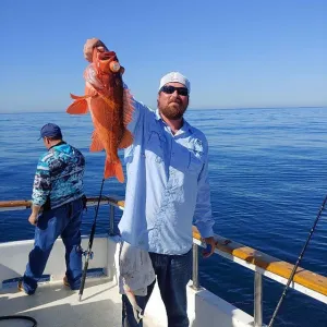 A man holding an orange fish